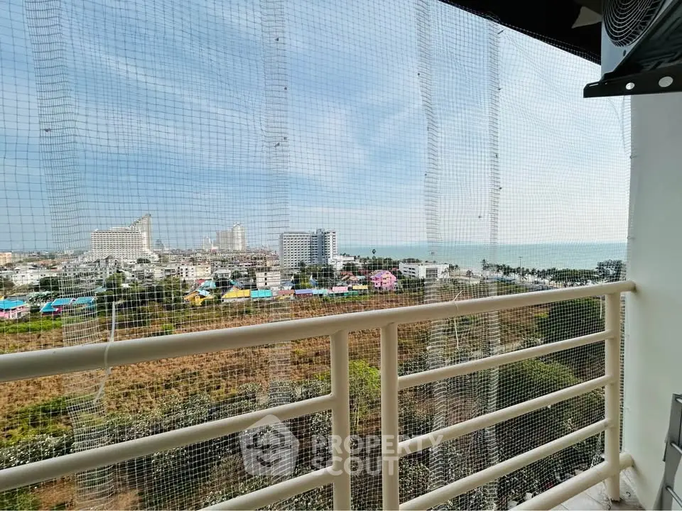 Stunning balcony view of cityscape and ocean, perfect for relaxation and enjoying the scenery.