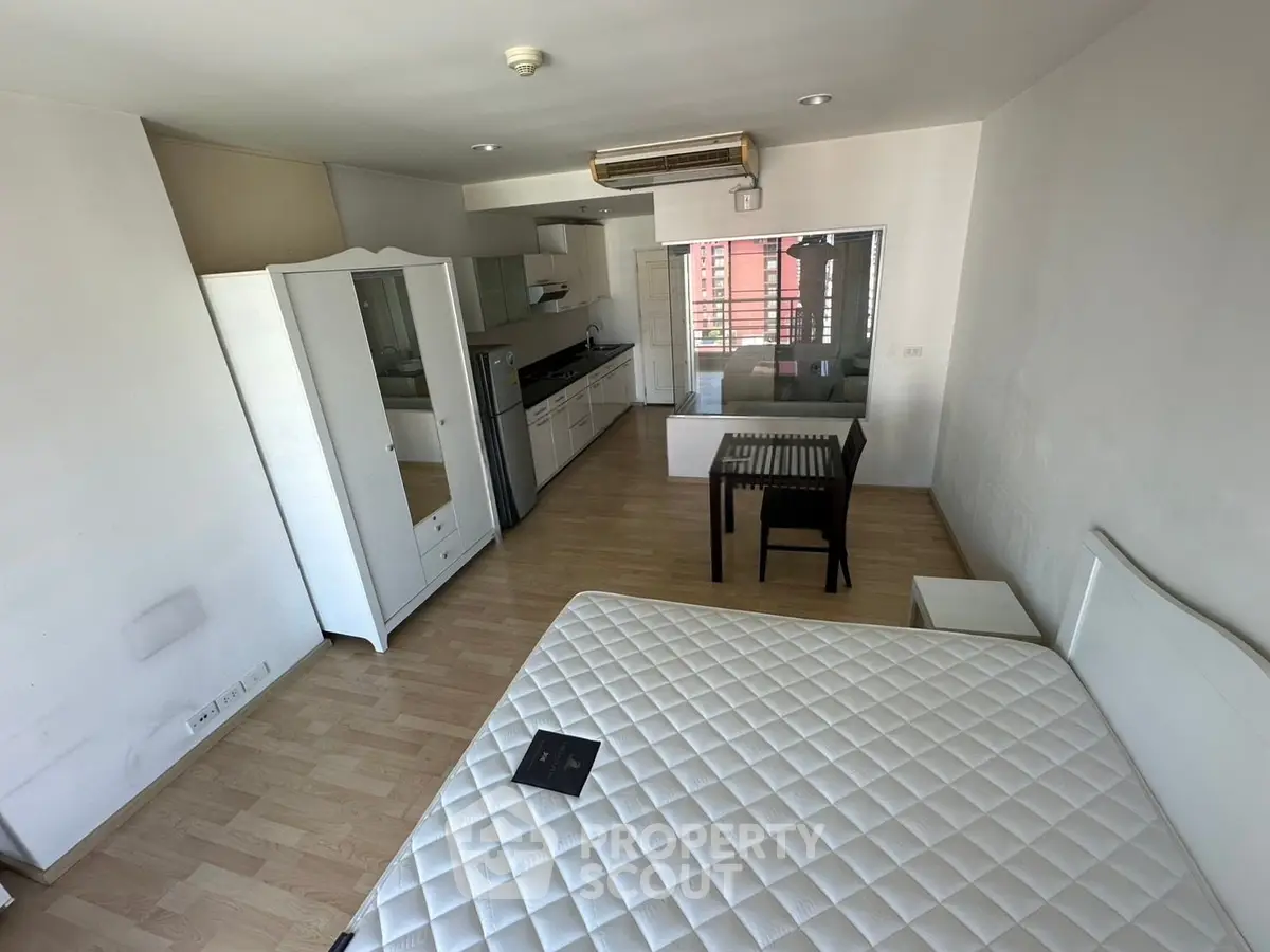 Spacious studio apartment with modern furnishings and open kitchen layout