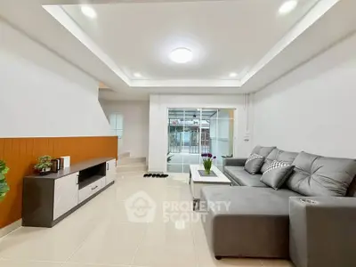 Modern living room with sleek design and comfortable gray sectional sofa.