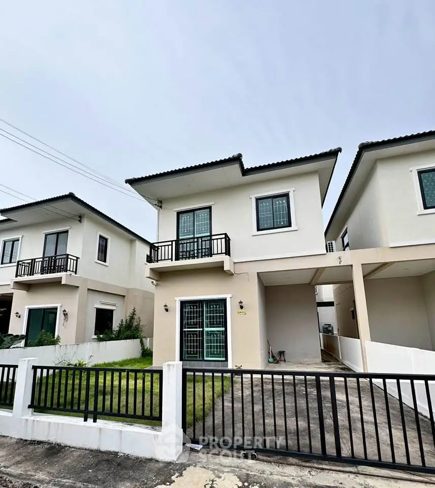 Charming two-story house with modern design and gated driveway in a serene neighborhood.