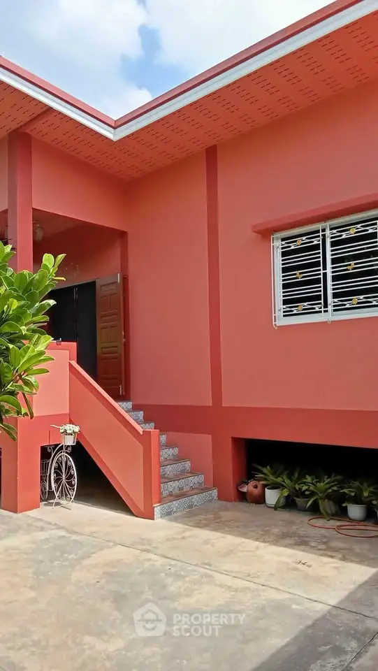 Charming single-story home with vibrant exterior and inviting entrance, perfect for family living.