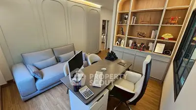 Modern study room with sleek desk, cozy sofa, and stylish shelving.
