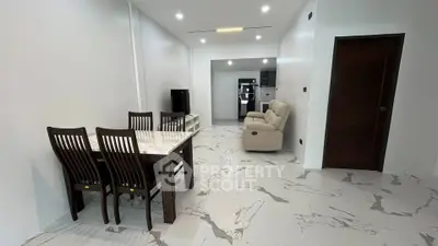 Spacious modern living room with marble flooring and elegant dining set