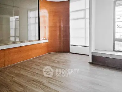 Spacious modern living room with wooden flooring and large windows