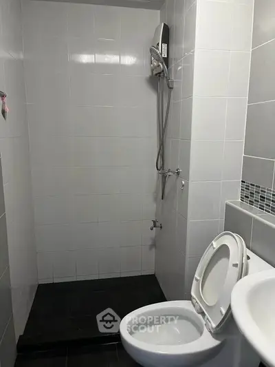 Modern bathroom with sleek white tiles and shower area