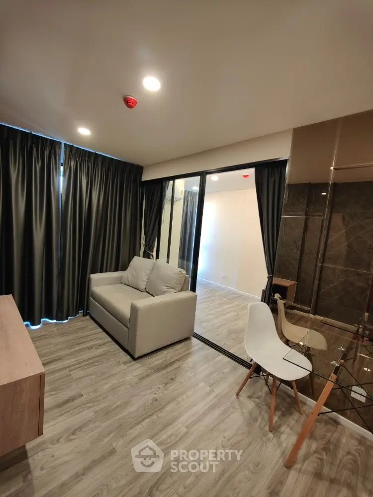 Modern living room with stylish decor and large windows in a contemporary apartment.