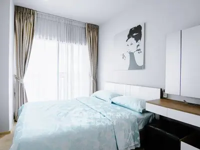 Modern bedroom with stylish decor and large window for natural light