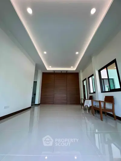 Modern minimalist living room with sleek design and recessed lighting