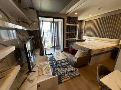 Modern studio apartment with stylish decor and city view balcony.