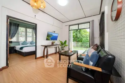 Charming living room with garden view, stylish decor, and cozy seating in a modern home.