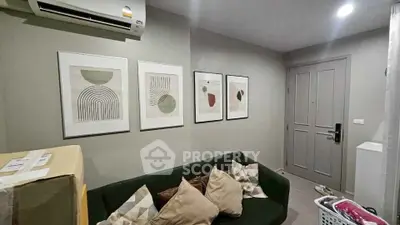 Cozy living room with modern art and comfortable seating in a stylish apartment.