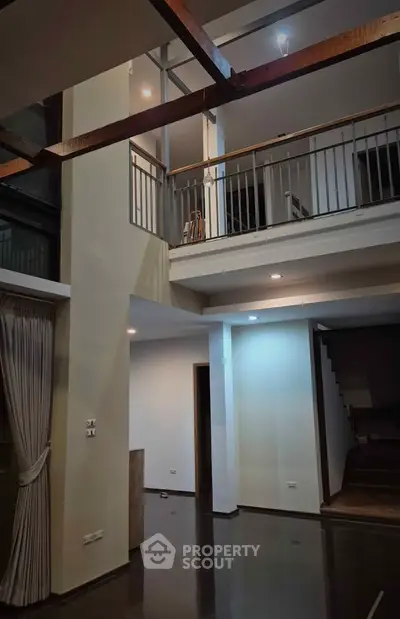 Spacious modern living room with high ceilings and elegant staircase