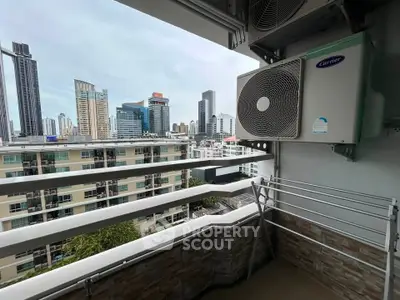 Stunning city view from a modern balcony with air conditioning unit and drying rack.