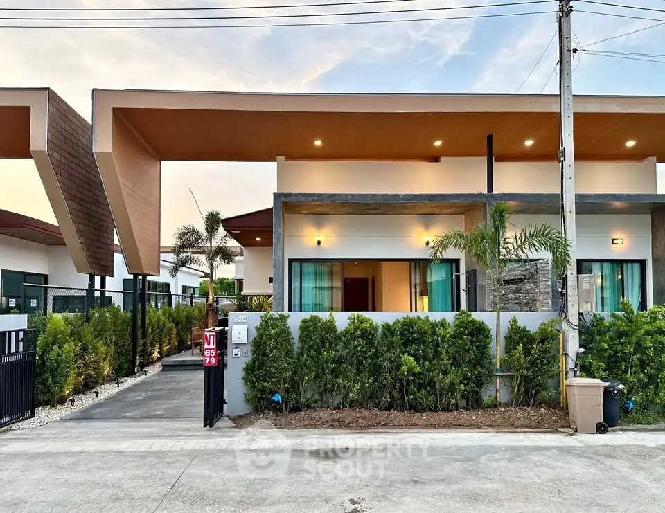Modern single-story house with unique roof design and lush greenery