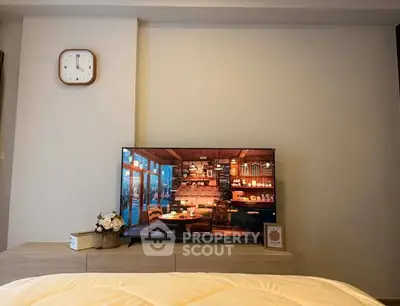 Cozy bedroom with modern TV and stylish decor