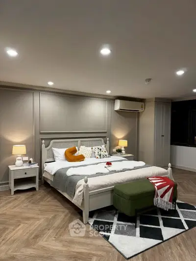 Luxurious bedroom with elegant decor and ambient lighting, featuring a stylish bed and cozy atmosphere.