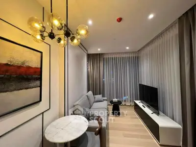 Modern living room with stylish decor and elegant lighting, featuring a cozy sofa and large TV.