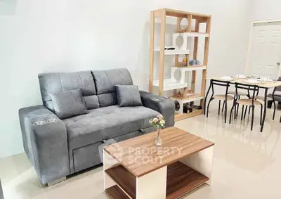 Modern living room with stylish gray sofa and wooden coffee table