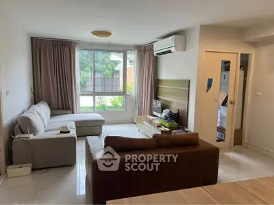 Spacious living room with modern furniture and large window view