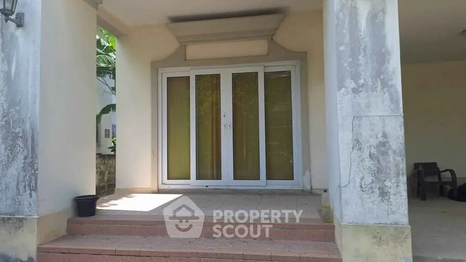 Charming entrance with double glass doors and covered porch, perfect for welcoming guests.