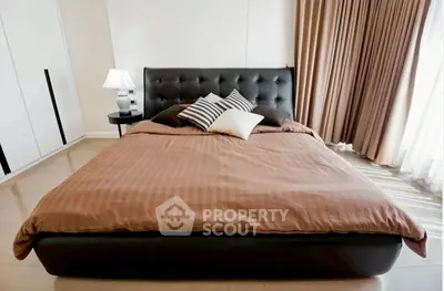 Luxurious bedroom with elegant decor and natural light, featuring a stylish bed and modern furnishings.