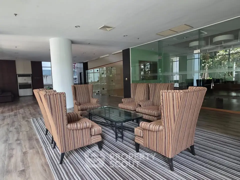 Spacious modern lobby with elegant seating and glass walls in a luxury building.