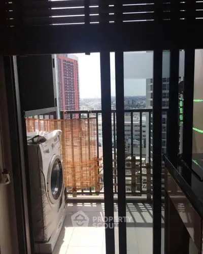 Modern apartment balcony with city view and washing machine setup.