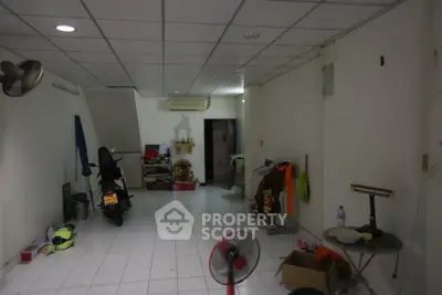 Spacious interior with tiled flooring, ideal for versatile use or storage, featuring ceiling fan and ample lighting.