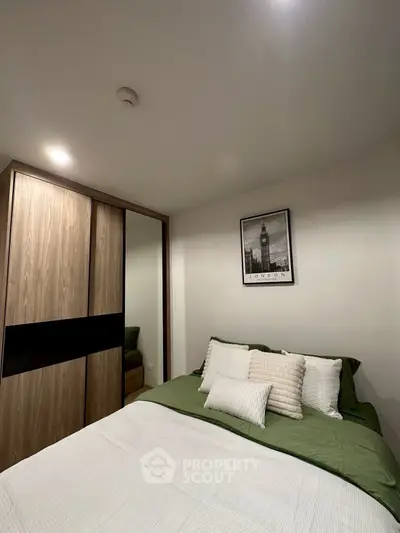 Cozy bedroom with modern decor and ample closet space in a stylish apartment.