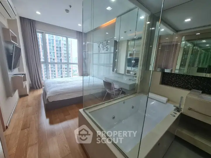 Luxurious bedroom with glass-enclosed bathtub and city view, perfect for modern living.