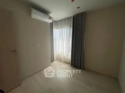 Bright empty room with air conditioning and large window, perfect for customization.