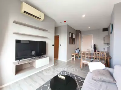Modern living room with sleek furniture and wall-mounted TV in a stylish apartment.