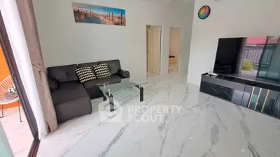 Modern living room with marble flooring and sleek black furniture