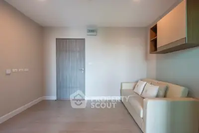 Modern minimalist living room with beige sofa and wooden door