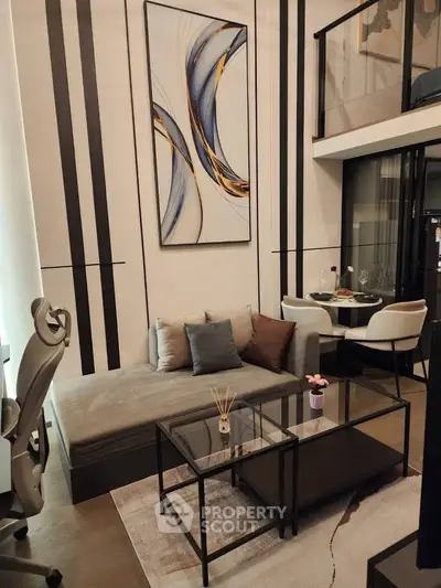 Modern living room with stylish decor and mezzanine level, featuring sleek furniture and contemporary artwork.