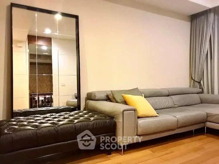 Stylish modern living room with elegant sofa and large mirror