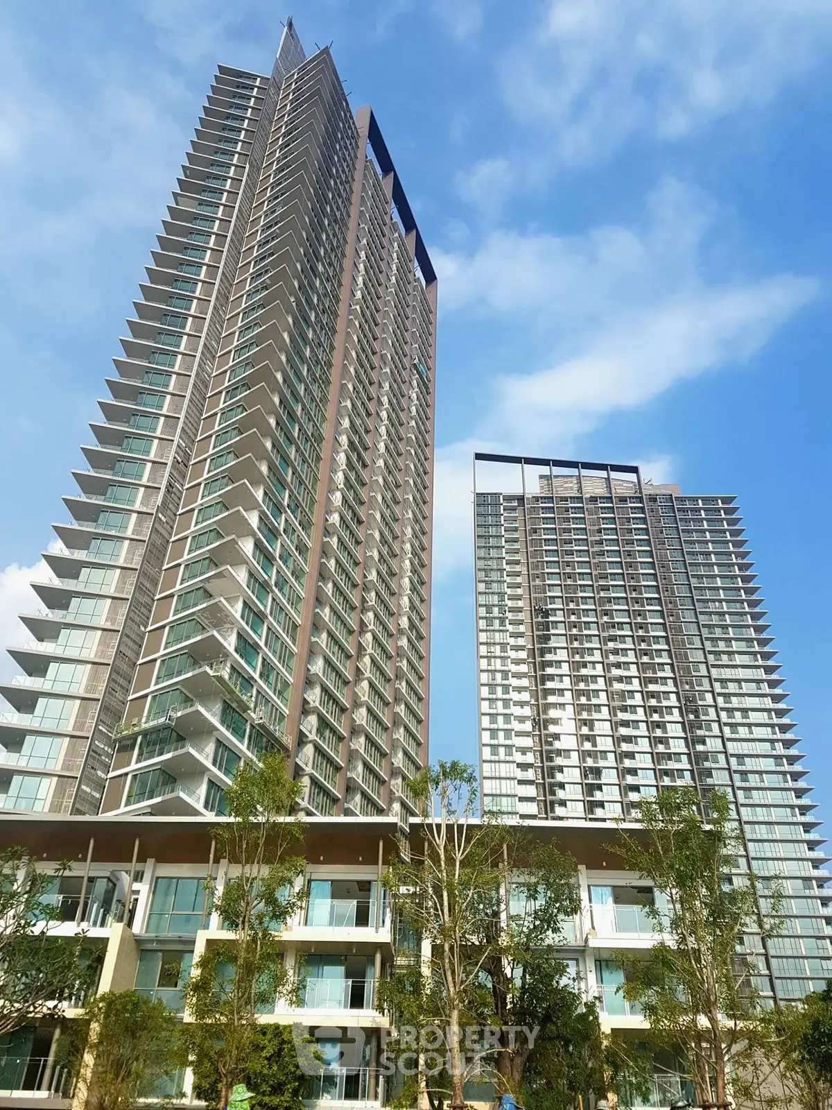 Stunning high-rise residential towers with modern architecture and lush greenery.