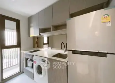 Modern kitchen with sleek appliances and ample storage space