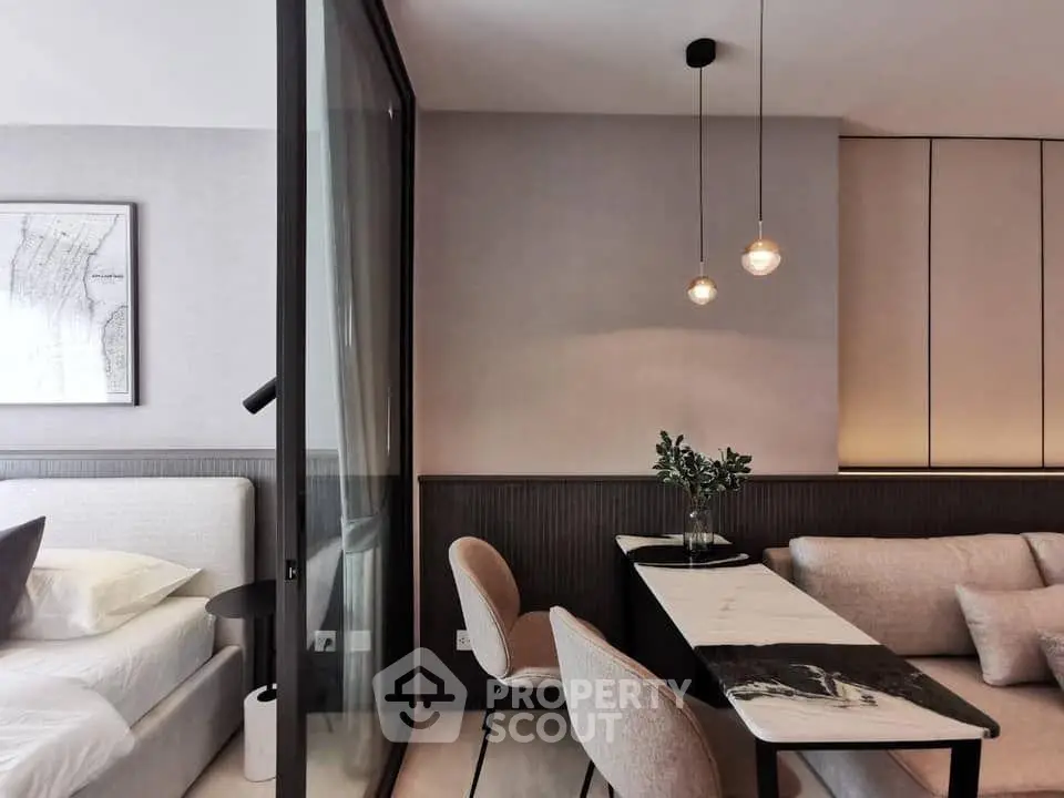 Modern living room with stylish dining area and cozy bedroom in open layout apartment.