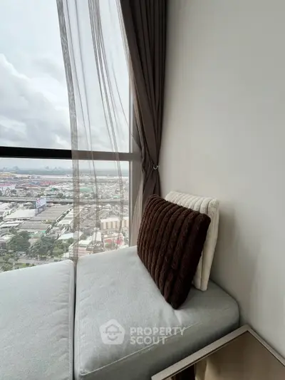Cozy corner unit with panoramic city view from a high-rise apartment window.