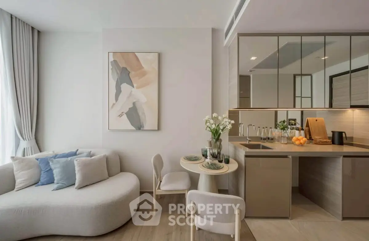 Modern open-plan living room with stylish kitchen and cozy seating area.