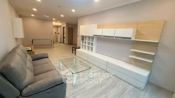 Spacious modern living room with sleek furniture and ambient lighting