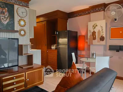 Stylish living room with modern decor, featuring a cozy seating area, dining table, and sleek kitchen appliances.