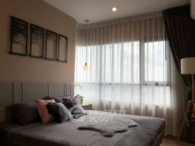 Cozy bedroom with large window and stylish decor in modern apartment