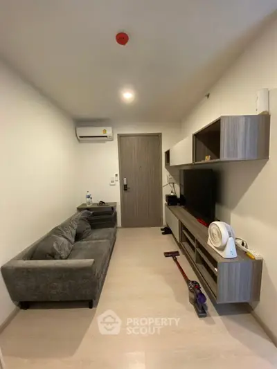 Modern compact living room with sleek furniture and wall-mounted TV unit
