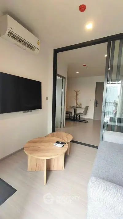 Modern living room with sleek furniture and open layout in a stylish apartment.