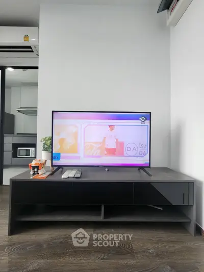 Modern living room with sleek TV stand and flat-screen TV, showcasing contemporary interior design.