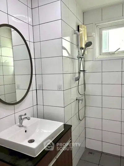 Modern bathroom with sleek white tiles and stylish fixtures