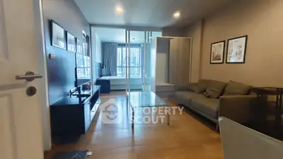 Modern living room with glass coffee table and cozy sofa in stylish apartment