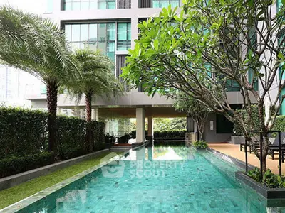 Luxurious condominium with stunning pool and lush greenery, perfect for relaxation and leisure.